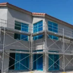 Two-story home under construction with blue protective glass, Miami, FL
